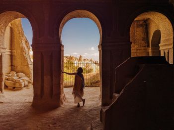 Woman standing at historical building