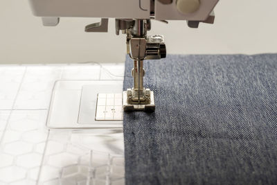 Close-up of textile being stitched in sewing machine