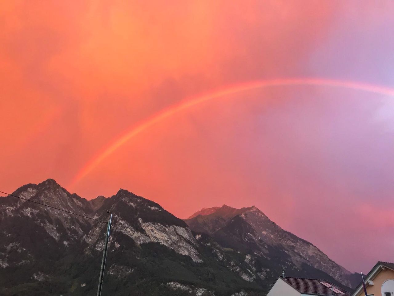 RAINBOW OVER MOUNTAINS AGAINST SKY