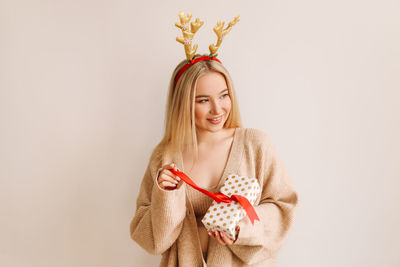 Young woman smiling against white background