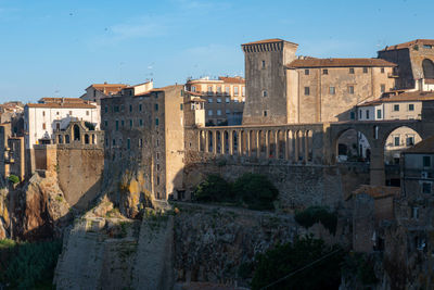 Pitigliano cityscape with buildings in early morning light in tuscany 