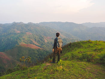 Trekking solo backpack on mountain trail in tropical forest at tak province, thailand.