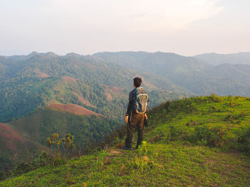 Rear view of man walking on mountain