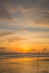 Scenic view of beach against sky during sunset