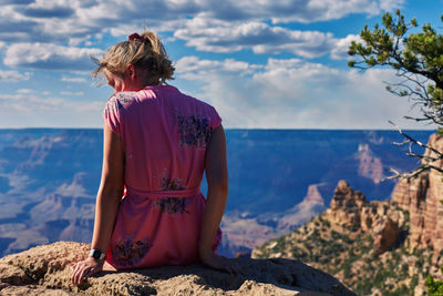 Rear view of woman looking at sea against sky