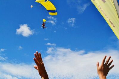 Cropped image of person flying kite against clear sky