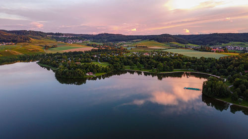 Scenic view of lake against sky during sunset