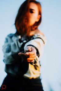 Low angle view of woman standing against sky