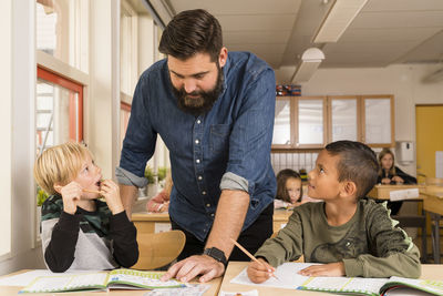 Teacher with boys in classroom