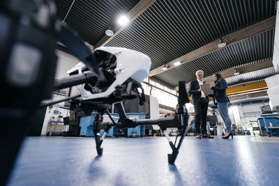 Businessman and coworker discussing production of drones