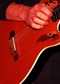 Close-up of hands playing guitar