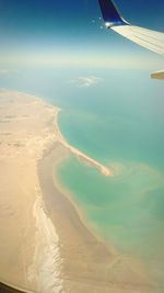 Aerial view of airplane wing over landscape