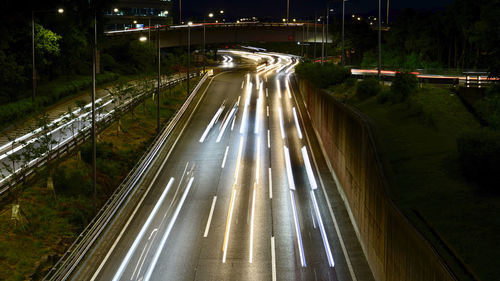 High angle view of light trails on highway at night