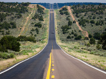 Lonely straight highway with just one car in arizona, usa