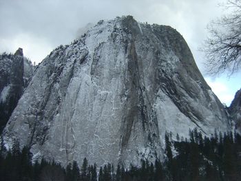 Low angle view of snowcapped mountain against sky