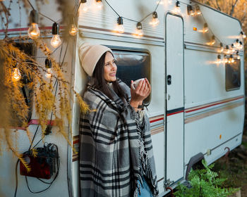 Portrait of young woman standing in train