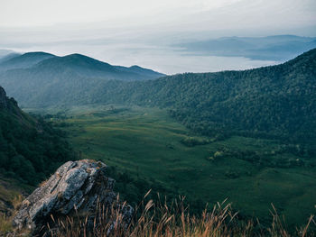 Scenic view of landscape and mountains against sky