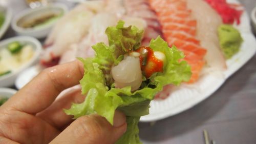 Close-up of hand holding salad