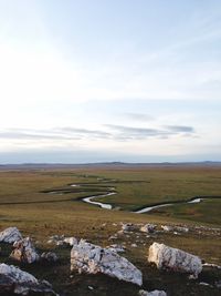 Scenic view of landscape against cloudy sky