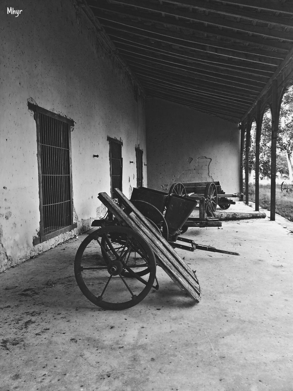 BICYCLE PARKED BY WALL OUTDOORS