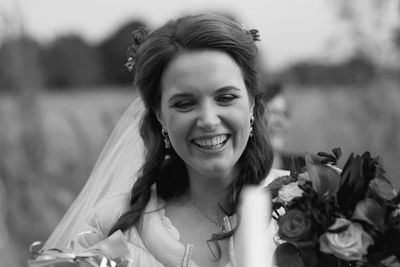 Close-up of smiling bride with flowers