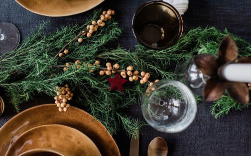 Greenery and berries on a decorated festive dinner table