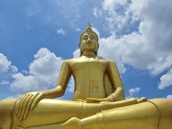 Low angle view of statue against temple against sky