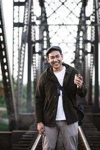 Portrait of smiling young man standing outdoors