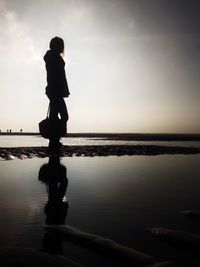 Silhouette of woman in sea
