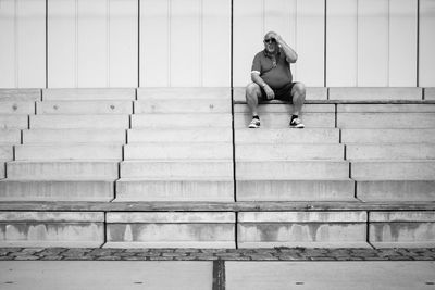 Full length of woman standing by railing