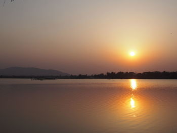 Scenic view of lake against sky during sunset