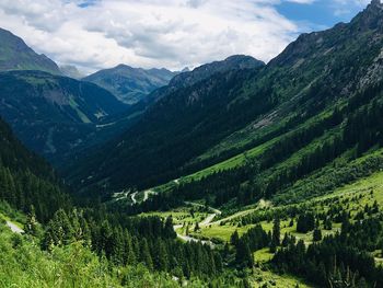 Scenic view of valley and mountains against sky