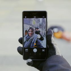 Portrait of woman photographing camera on mobile phone