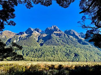 Scenic view of mountains against clear blue sky