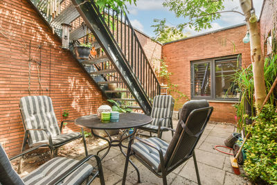 Empty chairs and tables in yard