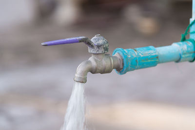 Close-up of faucet against blurred background
