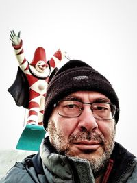 Portrait of man wearing hat against white background