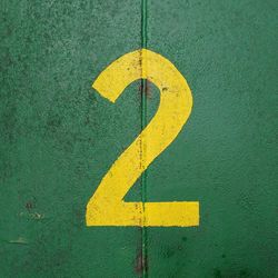 Close-up of yellow arrow sign