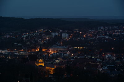 High angle view of illuminated city against sky at night