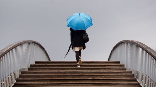 Low angle view of woman walking on staircase