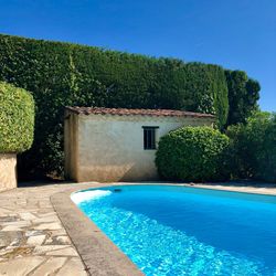 House by swimming pool against blue sky