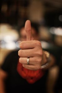 Close-up of man showing thumbs up sign 