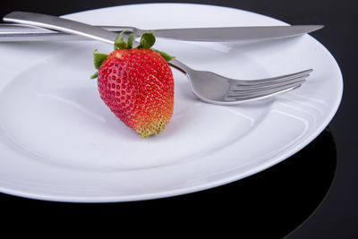 High angle view of strawberries in plate on table