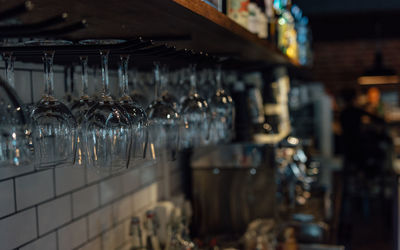 Upside down wineglasses hanging in bar