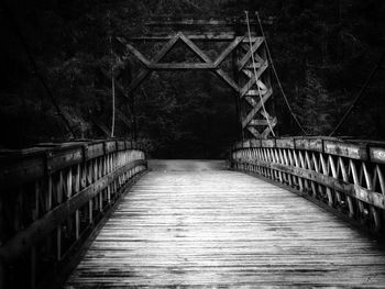 Empty footbridge along trees