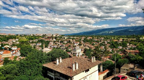 High angle shot of townscape against cloudy sky