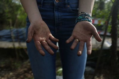 Midsection of person showing dirty hands