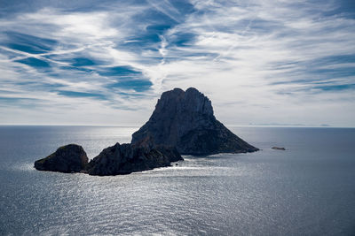 Rock formation in sea against sky