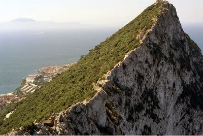 High angle view of rocks by sea against sky