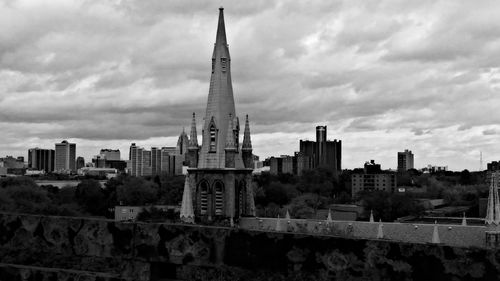 View of cityscape against cloudy sky